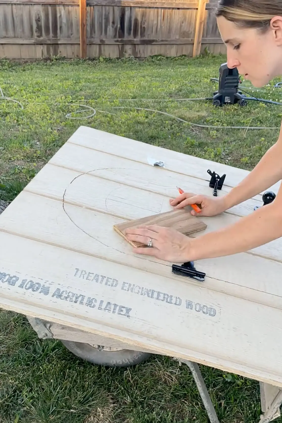 Drawing a window on the door of our backyard chicken coop.